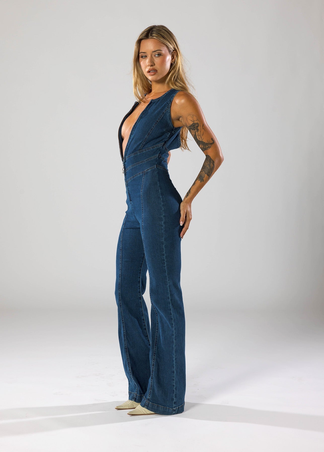 Women's Denim Jumpsuit with Deep V-Neck and Flared Leg Design
